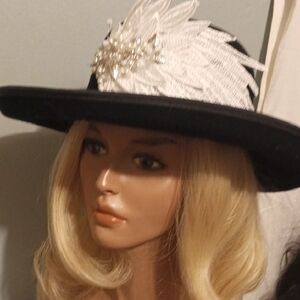 Elegant Black Hat with White Feather Accent